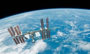 The International Space Station backdropped by Earth's horizon and the blackness of space.