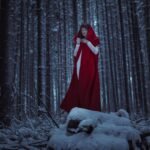 A woman standing in a snowy forest