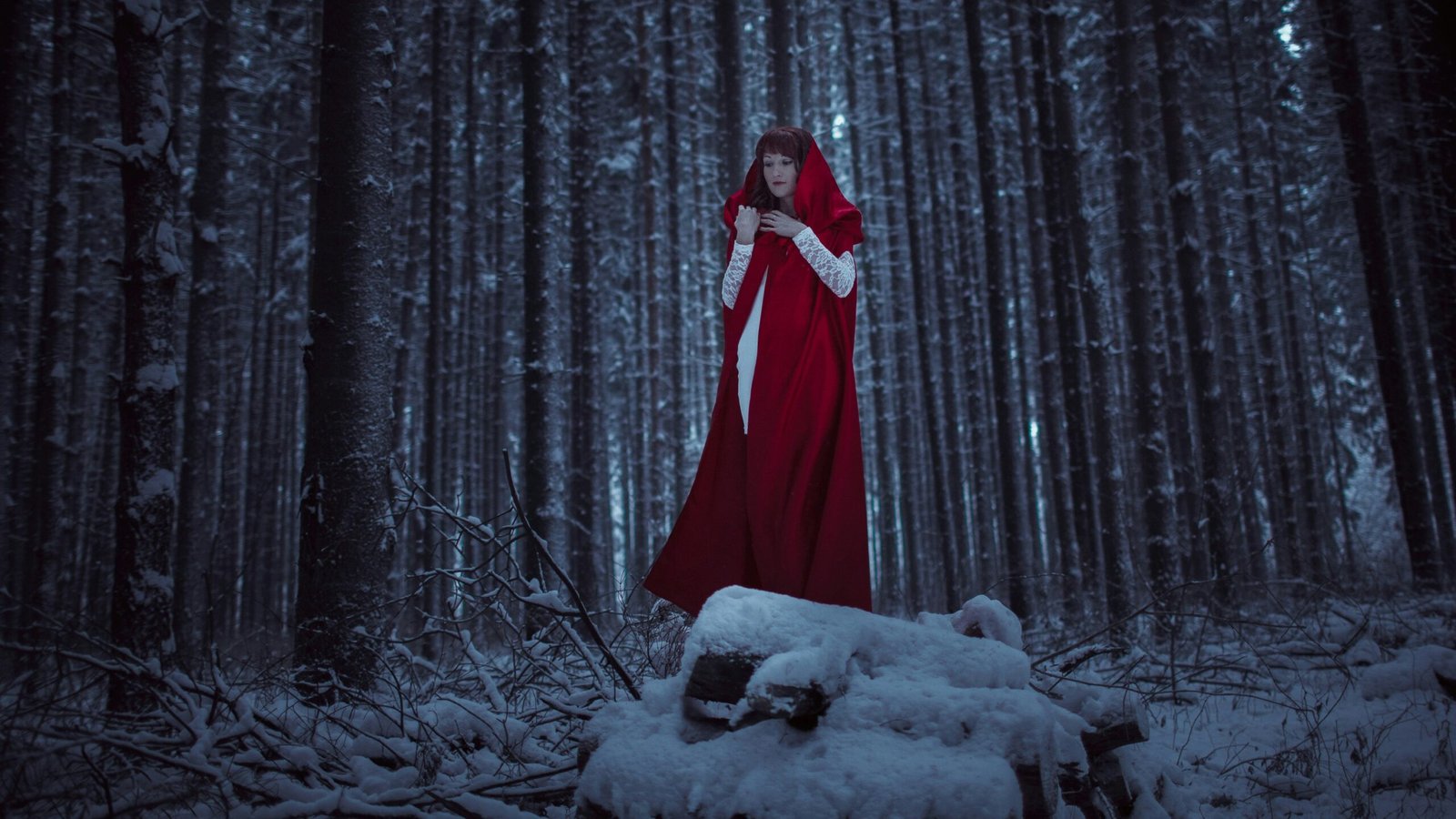 A woman standing in a snowy forest