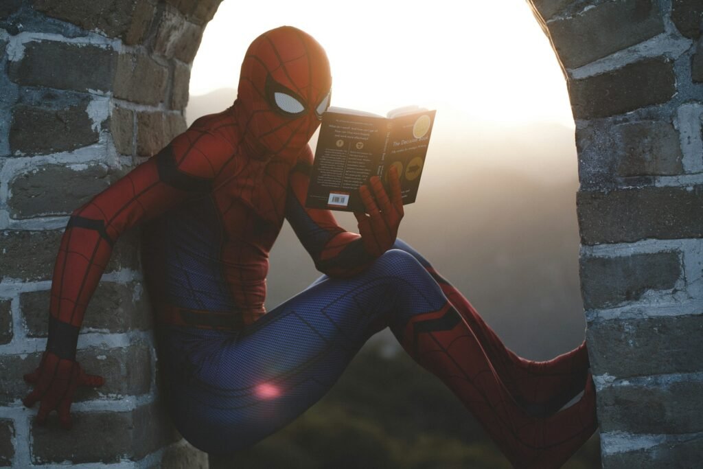 Spider man leaning on concrete brick while reading book