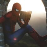 Spider man leaning on concrete brick while reading book
