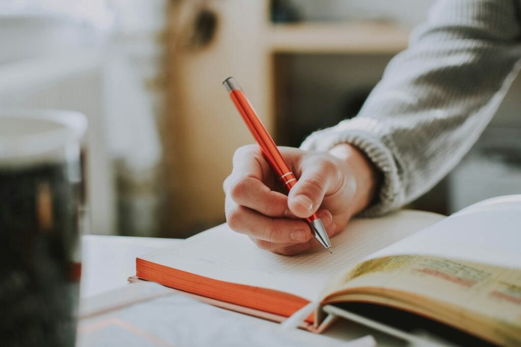 one person is journaling and coffee that table
