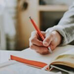 one person is journaling and coffee that table