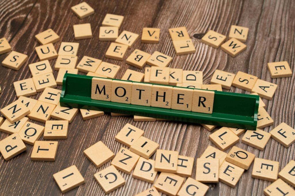 Letters ordered saying MOTHER and letter blocks scattered around it