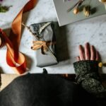 Gifts are placed on the table in front of a woman