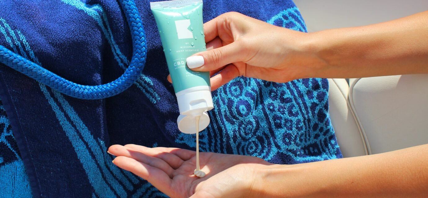 a women useing sunscreen in a beach