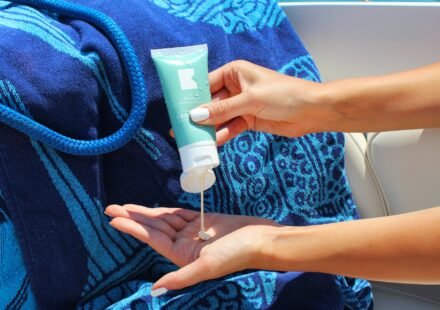 a women useing sunscreen in a beach