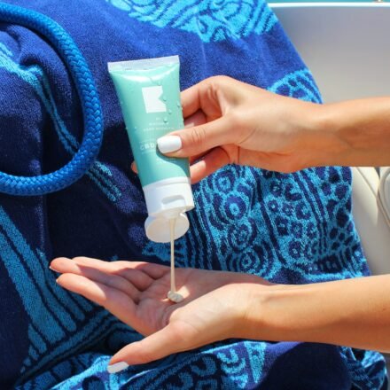 a women useing sunscreen in a beach